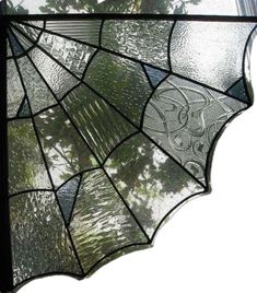 a stained glass umbrella hanging from the side of a window