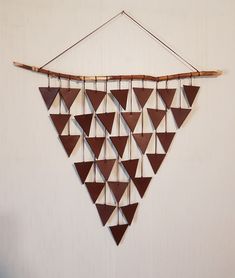 a wall hanging made out of wooden triangles