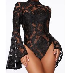 a woman wearing a black bodysuit with sheer lace