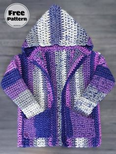 a crocheted purple and white jacket on a wooden surface with the text free pattern