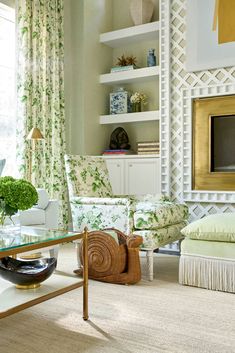 a living room filled with furniture next to a window covered in green and white curtains