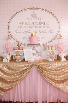 a pink and gold princess birthday party with cake, cupcakes, candies and decorations