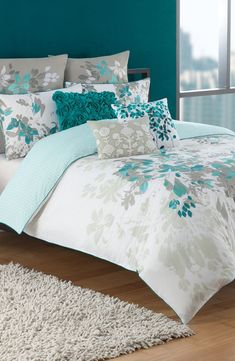 a bed with blue and white comforters in a room