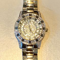 Brand New, Exquisite! Beautiful Simulated Baguettes And Round Diamonds And Blue Sapphires Inside Face And Outside, For The Person That Likes To Look Like A Million Dollars. Stainless Steel Back With Quartz Movements. Great Condition Except Needs New Battery. Fits Wrist Size Medium To Large Measures Approximately 8 Inch’s , Can Have Link’s Removed If Too Large. Code# B9825 Silver Diamond Watch With Palladium Hardware, Silver Diamond Watch With Diamond Hour Markers For Evening, Luxury Formal Watches With Rhinestones, Timeless Diamond Watch With Rhinestones For Formal Occasions, Luxury Silver Diamond Watch For Evening, Timeless Silver Jewelry With Rhinestones, Modern Silver Diamond Watch As Gift, Modern Silver Diamond Watch For Gift, Silver Bling Jewelry And Watches As Gift