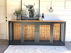 a cow is on top of a black cabinet