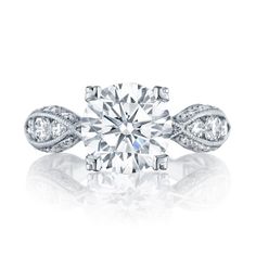 a diamond engagement ring with two diamonds on the side and an intricate band around it