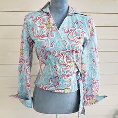 This Cute And Unusual Shirt Has An Awesome Print With Shades Of Pink With Green Eyes Octopus (What Is The Plural??) On A Tiny Blue Speckled Background. The Brand Is Cj Laing And It Is Still New With Tags. It Is Tagged A Size Small. I Had It On A Size 6 Mannequin And It Was A Little Loose. It Wraps Around The Front Then There Are Long Ties To Knot In Either The Front Or Back. The Long Sleeves Have Extra Long Cuffs That Can Turn Upwards. There Are Single Buttons On Each Cuff. Material Is 97% Cotto Pink Fitted V-neck Shirt, Pink Fitted Cotton Shirt, Fitted Pink Cotton Shirt, Blue Fitted Cotton Blouse, Fitted Blue Cotton Blouse, Fitted Pink Cotton Blouse, Pink Octopus, Turquoise Blouse, Aeropostale Hoodies