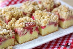 a close up of a piece of cake on a plate with crumb toppings