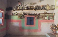 an old kitchen with pots and pans on the wall