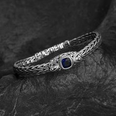 Adorn your wrist with the Eternal Elegance Blue Corundum Bracelet, a piece that seamlessly blends antique charm with modern sophistication. Finely crafted from S925 sterling silver, this bracelet features a captivating blue corundum stone at its heart, surrounded by sparkling inlaid zircon. Perfect for any occasion, it adds a touch of timeless beauty to any attire. - Material: S925 sterling silver - Length: Approximately 20cm - Width: Approximately 10mm - Weight: 37g - Inlaid: Zircon - Centerpie Viking Arm Rings, Iron Necklace, Beard Accessories, Wolf Necklace, Viking Ring, Viking Bracelet, Viking Necklace, Woven Bracelet, Dragon Necklace