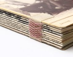 a stack of magazines with pink thread on them