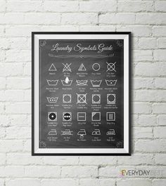 laundry symbols poster hanging on a brick wall