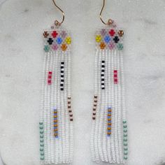 the beaded earrings are decorated with multicolored beads