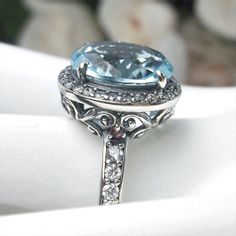 Aquamarine Sterling Silver RingHalo Design #D228 If you have a penchant for classic vintage jewelry, then this beautiful simulated aquamarine Halo Ring #D228 is just the thing for you. Crafted with love in sterling silver filigree and a magnificent centerpiece – an 11x9mm Sky Blue gemstone – this ring is sure to become your favorite piece of jewelry. With all the amazing & intricate details plus the lovely oval center stone, this Art Deco design will surely turn heads and get attention wherever Classic Light Blue Aquamarine Jewelry, Elegant Light Blue Rings For Formal Occasions, Light Blue Halo Wedding Jewelry, Classic Light Blue Jewelry For Formal Occasions, Light Blue Classic Jewelry For Formal Occasions, Classic Light Blue Formal Jewelry, Classic Light Blue Oval Jewelry, Handmade Blue Topaz Ring, Handmade Elegant Blue Topaz Ring