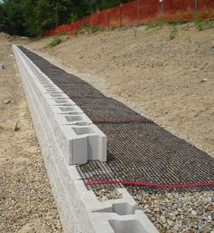 concrete blocks are laid on the ground to be constructed into a retaining wall for an outdoor area