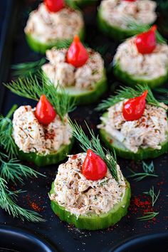 cucumbers stuffed with tuna and tomatoes on a baking sheet, ready to be served