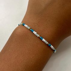 a person's arm with a bracelet on it