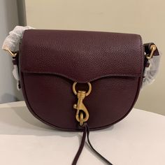 Beautiful Wine Color Leather Saddle Style Bag In New Condition Never Used. No Flaws That I Can Find. Formal Purple Shoulder Bag With Branded Hardware, Chic Purple Bags With Branded Hardware, Purple Satchel With Gold-tone Hardware For Travel, Purple Satchel With Gold-tone Hardware For Daily Use, Everyday Purple Satchel With Gold-tone Hardware, Travel Bag With Purple Color And Gold-tone Hardware, Burgundy Crossbody Shoulder Bag With Branded Hardware, Luxury Purple Satchel With Gold-tone Hardware, Purple Shoulder Bag With Gold-tone Hardware For Everyday Use