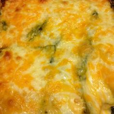 a close up view of a cheesy casserole with broccoli and cheese