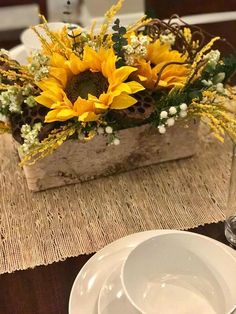 sunflowers and baby's breath in a wooden box on a place setting