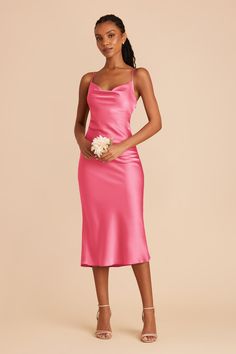 a woman wearing a pink satin slip dress