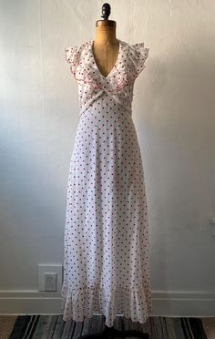 Vintage 1970s red and white polka dot dress, There are two layers of fabric, the solid white cotton lining. The outside is a cotton/blend but the ruffles is a much sheerer organza and a slightly different shade of white. Nylon zipper back of waist. Hook and eyes back of neck. The thread eyes are starting to unravel so you may want to replace them in the future.  Very good condition, around the hem a little discoloration along with a few tiny pinhead black marks.  Measurements... Bust - 34 inches Waist - 28 inches Hips - 38 inches Length mid shoulder to hem - 57 inches 1970s Women, White Polka Dot Dress, Dress Gown, Shades Of White, Polka Dot Dress, Dot Dress, Vintage 1970s, Dress Clothes For Women, White Polka Dot