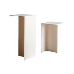 two white pedestals sitting next to each other on a white background, one is empty