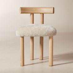 Inspired by modern Parisian apartments, the Perle natural shearling dining chair by goop is a sleek take on a classic silhouette with its deep, armless profile, vertical lines and contoured T-back. Soft, tactile shearling provides an elegant counterpoint to the lightly wirebrushed and cerused American white oak certified sustainable by the Forest Stewardship Council r FSC, while an unlacquered brass andamp;quot;gandamp;quot; medallion on the front leg lends a refined final flourish. Whether in t Black Leather Bed, Modern Parisian Apartment, Modern Parisian, Wood Canopy, Chairs Dining Room, Wood Counter Stools, Leather Sectional Sofa, Grey Dining, Leather Bed