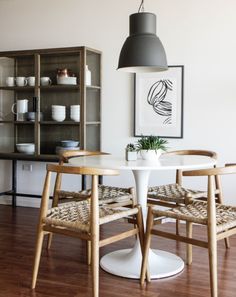 a dining room table with two chairs around it