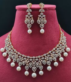 Explore the harmonious fusion of American innovation and Indian craftsmanship embodied in our latest American Diamonds necklace set, part of our Luxe Royal Heritage collection. Designed in the USA and intricately handcrafted in India, this piece showcases delicate floral motifs radiating elegance. Its lightweight design seamlessly complements any attire, elevating your style with versatility and sophistication. Symbolizing cross-border collaboration and creative synergy, it goes beyond being a m Ad Necklace Set, American Diamond Necklaces, Necklace Matching, Diamond Necklace Designs, Diamonds Necklace, Silver Wedding Jewelry, Earrings Stone, Diamond Necklace Set, Cz Necklace