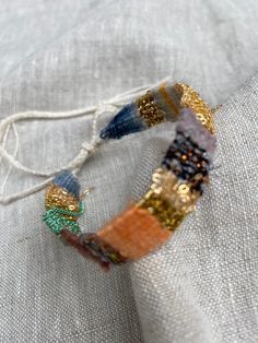 a close up of a piece of cloth with beads on it