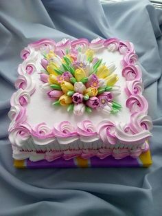 a decorated cake sitting on top of a bed