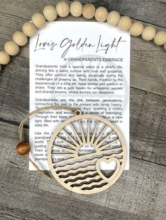 a wooden necklace with an image of a tree and the words, love's golden light