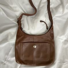 Barely Used Caramel Brown Leather Coach Crossbody Messenger Bag. One Outer [Pocket With Snap Closure; Three Inner Pockets, One Has A Zipper Closure. The Long Shoulder Strap Is Adjustable With Silver Tone Buckle. Strap Measures Approximately 38" Inches Long By 1.75" Wide. The Purse Itself Measures 13" Inches Side By 9.75" Inches High. Classic Crossbody Bags With Pockets, Classic Brown Shoulder Bag With Pockets, Classic Brown Shoulder Bag With Cell Phone Pocket, Leather Hobo Bag With Pockets For On-the-go, Classic Brown Crossbody Hobo Bag, Classic Dark Tan Crossbody Shoulder Bag, Elegant Leather Shoulder Bag With Pockets, Elegant Brown Shoulder Bag With Pockets, Coach Crossbody Shoulder Bag With Cell Phone Pocket