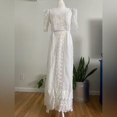 Stunning Vintage 70s Handmade Cottagecore/Prairie/Boho Wedding Maxi Dress. Beautiful Mesh Top With High Neck And Lace Aplique Throughout The Entire Dress. The Outer Part Of The Dress Seems To Be Made Of Cotton Fabric And Is Lined With Polyesters From The Bust All The Way Down To The Bottom Hem. The Dress Is Missing It’s Original Belt, But Is Otherwise In Great Vintage Condition With No Noted Flaws Such As Missing Buttons, Stains Or Holes. No Size Tag, But Would Best Fit A Modern Small To Medium. Measurements: Shoulder To Shoulder-18” Bust/Armpit To Armpit-17” Waist-13.5” Length/Shoulder To Bottom-54” Sleeves Length-12.5” Hips-20.5” ***All Measurements Taken With Item Laying White Lace Vintage Dress For Garden Party, Vintage Floor-length Wedding Dress, Vintage White Floor-length Wedding Dress, Cottagecore Vintage Wedding Dress With Lace Trim, Cottagecore Fitted Wedding Dress, White Vintage Summer Wedding Dress, Cottagecore Wedding Dress With Fitted Bodice, Fitted Lace Trim Wedding Dress For Beach, White Cottagecore Maxi Dress For Garden Party