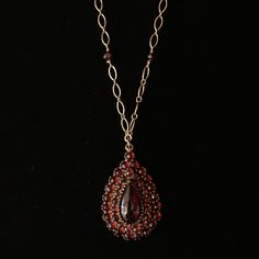 Elevate your style with the mesmerizing allure of Bohemian garnets! Renowned for their deep, wine-red hue and exceptional brilliance, these garnets were highly favored during the Victorian era, symbolizing passion and devotion. Very rare necklace made with Bohemian garnets in the Victorian Era Set on an 18" goldfill chain w/ secure lobster clasp, accented with 6 garnet beads Bohemian garnet center gemstone measures approx. 14x7mm, surrounded by thirty-eight garnets, ranging in size from 2mm-2.5m Garnet Briolette Beads For Jewelry Making, Garnet Briolette For Jewelry Making, Elegant Garnet Necklace For Formal Occasions, Elegant Pear-shaped Ruby Jewelry, Luxury Garnet Pendant Necklace, Formal Garnet Fine Jewelry Necklace, Elegant Ruby Teardrop Pendant Necklace, Formal Ruby Drop Necklace, Formal Drop Ruby Necklaces