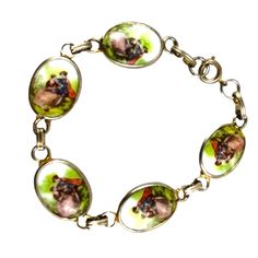 This exquisite Fragonard vintage bracelet features hand-painted porcelain cameos depicting an enchanting romantic scene. Each cameo is delicately encased in a gold-tone setting and linked together to form an elegant chain. Ideal for a sophisticated accessory or a charming gift, this bracelet combines timeless beauty with intricate craftsmanship. * Hand-painted porcelain cameos * Gold-tone settings * Romantic scene artwork * Linked chain design * Secure clasp closure * Vintage craftsmanship 7 inc Antique Gold Enamel Bracelets, Vintage Gold Enamel Bracelets, Collectible Gold Bracelets With Cabochon, Antique Enamel Bracelets As Gift, Antique Enamel Bracelet Collectible, Antique Enamel Bracelets For Gifts, Vintage Enamel Cameo Jewelry, Vintage Cameo Enamel Jewelry, Vintage Cameo Jewelry In Enamel