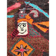 an old rug with colorful designs on it