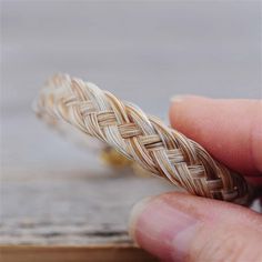 a hand holding a piece of woven material