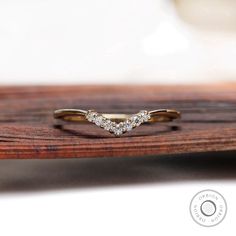 a diamond ring sitting on top of a wooden table