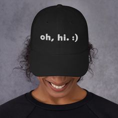 Need a trendy, modern hat for a birthday gift, Father's Day, or another fun occasion? Grab this minimalist hat from our shop, for any person and any age! ~~ THE "OH HI" DAD HAT~~ Oh, hi! A simple, silly hat that serves as a great icebreaker in public. This cap is sure to get some smiles as you rock it in public, why not pick one up? This hat Means Minimal. ~~ WELCOME TO MEANS MINIMAL. ~~ Welcome, thanks for much for visiting! Our products are here to help you embody a minimalist, flowing, and simple lifestyle. We keep your fits modern and your faces happy.  ~~ MORE DETAILS ~~ * 100% chino cotton twill * Unstructured, 6-panel, low-profile * 6 embroidered eyelets * 3 ⅛" (7.6 cm) crown * Adjustable strap with antique buckle and curved visor * Sourced from Vietnam or Bangladesh Oh Hi Modern Ha Funny Adjustable Dad Hat Baseball Cap, Funny Black Hats For Gifts, Funny Black Hats For Gift, Funny Baseball Cap With Curved Bill, Funny Black Hat For Gift, Funny Black Hat As Gift, Black Dad Hat Cap As A Gift, Black Dad Hat As A Gift, Black Dad Hat With Curved Brim As Gift