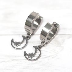 Your new favorite hoops! 🔥 A small moon and star silhouette hangs from awesome thick stainless steel hoop earrings made by our talented artist Diamonds and Coal! Perfect for everyday wear, they are both dainty and edgy, perfect for the office or wearing out on a Friday night. About these earrings: Size: approx: .75” tall Materials: Stainless steel (means no tarnishing ever!) Hypoallergenic too! Silver stainless steel One Pair Everyday Stainless Steel Pierced Hoop Earrings, Everyday Stainless Steel Dangle Hoop Earrings, Casual Stainless Steel Dangle Hoop Earrings, Nickel-free Stainless Steel Hoop Cartilage Earrings, Minimalist Stainless Steel Dangle Hoop Earrings, Small Hoop Surgical Steel Earrings As Gift, Small Hoop Surgical Steel Earrings For Gift, Small Hoop Earrings In Surgical Steel As Gift, Surgical Steel Small Hoop Earrings For Gifts