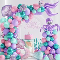 an under the sea themed birthday party with balloons, decorations and mermaid tailes on display