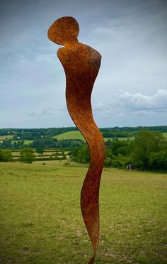 a metal sculpture in the middle of a field