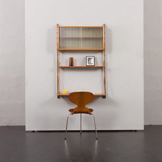 a chair sitting in front of a book shelf