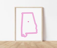 a neon pink outline of the state of indiana on a white wall in an empty room