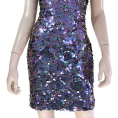 "This 80s-era trophy dress features a fun mermaid scale pattern of iridescent purple sequins and gold beads, a halter neck bodice with open back, and mini length skirt. Perfect for holidays, special occasions, or any time you need to glam it up a bit. Dress is unlined and zips up the back. Best fits size xs or small (please check measurements below). Accessories not included. Payment plans available. Approximate Flat Measurements: Multiply times 2 for bust, waist, and hip measurements. For best Sequin Mermaid Dress For Party Season, Mermaid Dress With Sequins For Party Season, Purple Sequin Dress For Prom Season, Purple Sequin Dress For Prom, Purple Sequin Dress For Summer, Embellished Fitted Disco Mini Dress, Embellished Fitted Mini Dress For Disco, Fitted Embellished Mini Dress For Disco, Prom Season Mermaid Sequin Dress