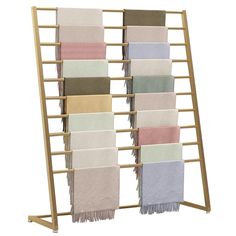 a rack with towels hanging from it's sides and four different colors on each side