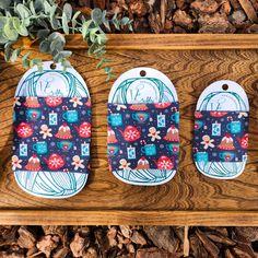 three oven mitts are sitting on a wooden surface next to a potted plant