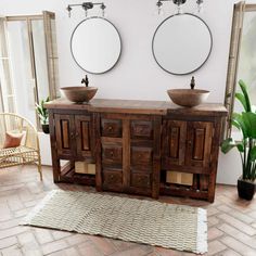 a bathroom with two sinks and mirrors on the wall next to a potted plant